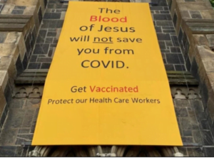 Read more about the article “The Blood of Jesus will not save you from Covid…”: the story of a controversial banner set up by a protestant pastor.